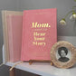 Pink book titled 'Mom, I Want to Hear Your Story' on a shelf with a photo frame.